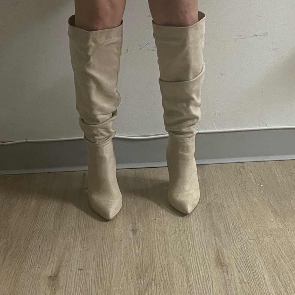 High heel knee length boots . Pull on .